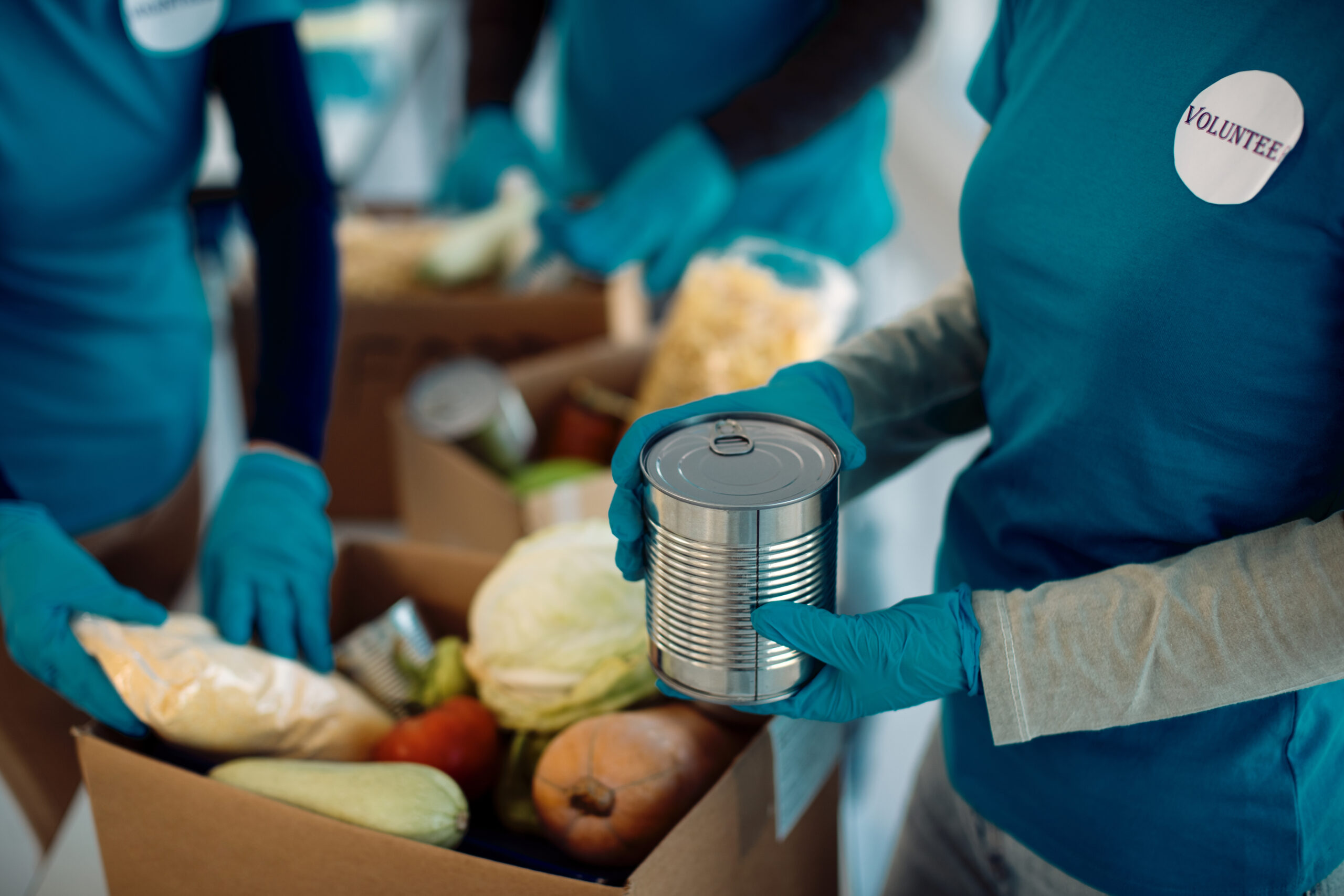 Volunteers packing cardboard boxes with food items.
Picture by Drazen.