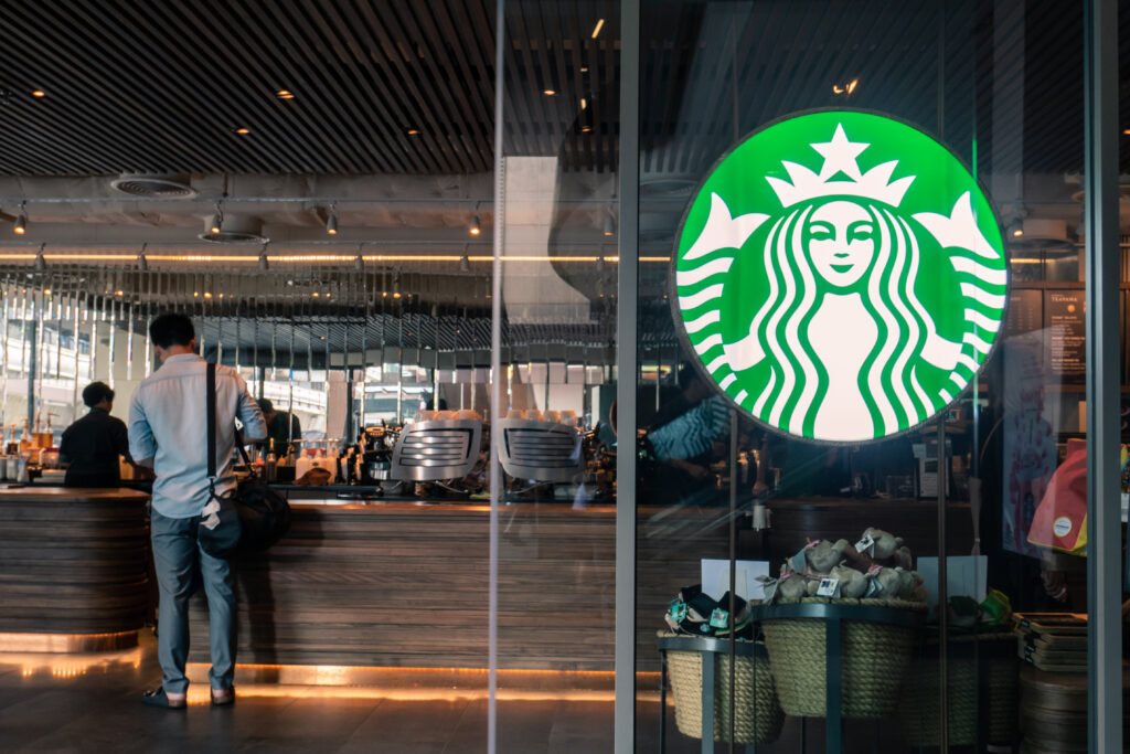 Inside of a coffee shop with Starbucks logo on the glass door.
Picture by Wachiwit.